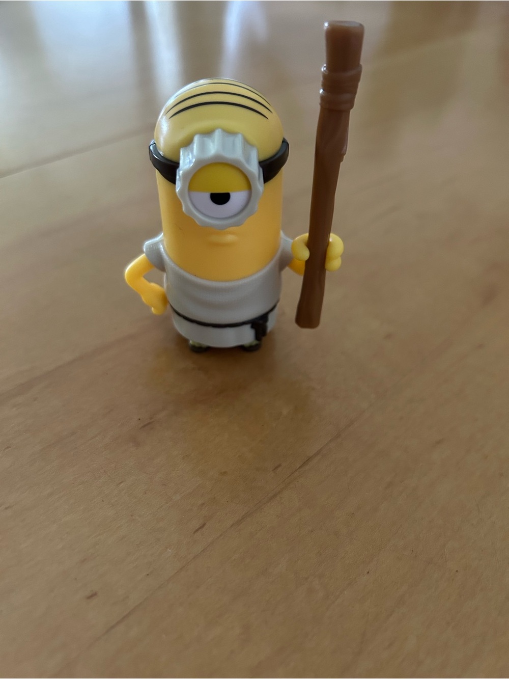 One-Eyed Yellow Action Figure with Brown Staff - Classic Cartoon Style